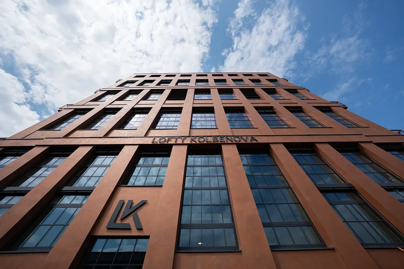 Brick facade of the Lofty Kolbenova building with large windows